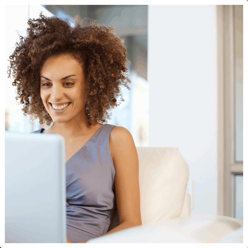 Woman smiling during her Virtual Hair Consultation with a Bounce Curl hairstylist 