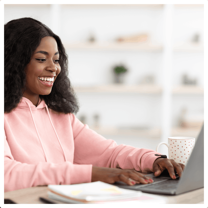 Woman smiling during her Virtual Hair Consultation with a Bounce Curl hairstylist