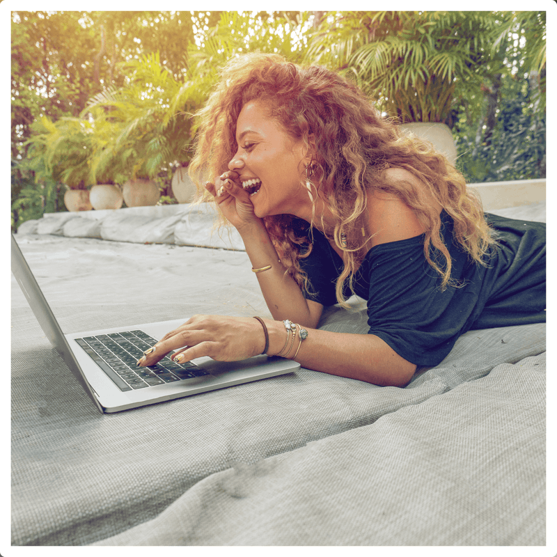 Woman laughing during her virtual hair consultation with bounce curl stylist